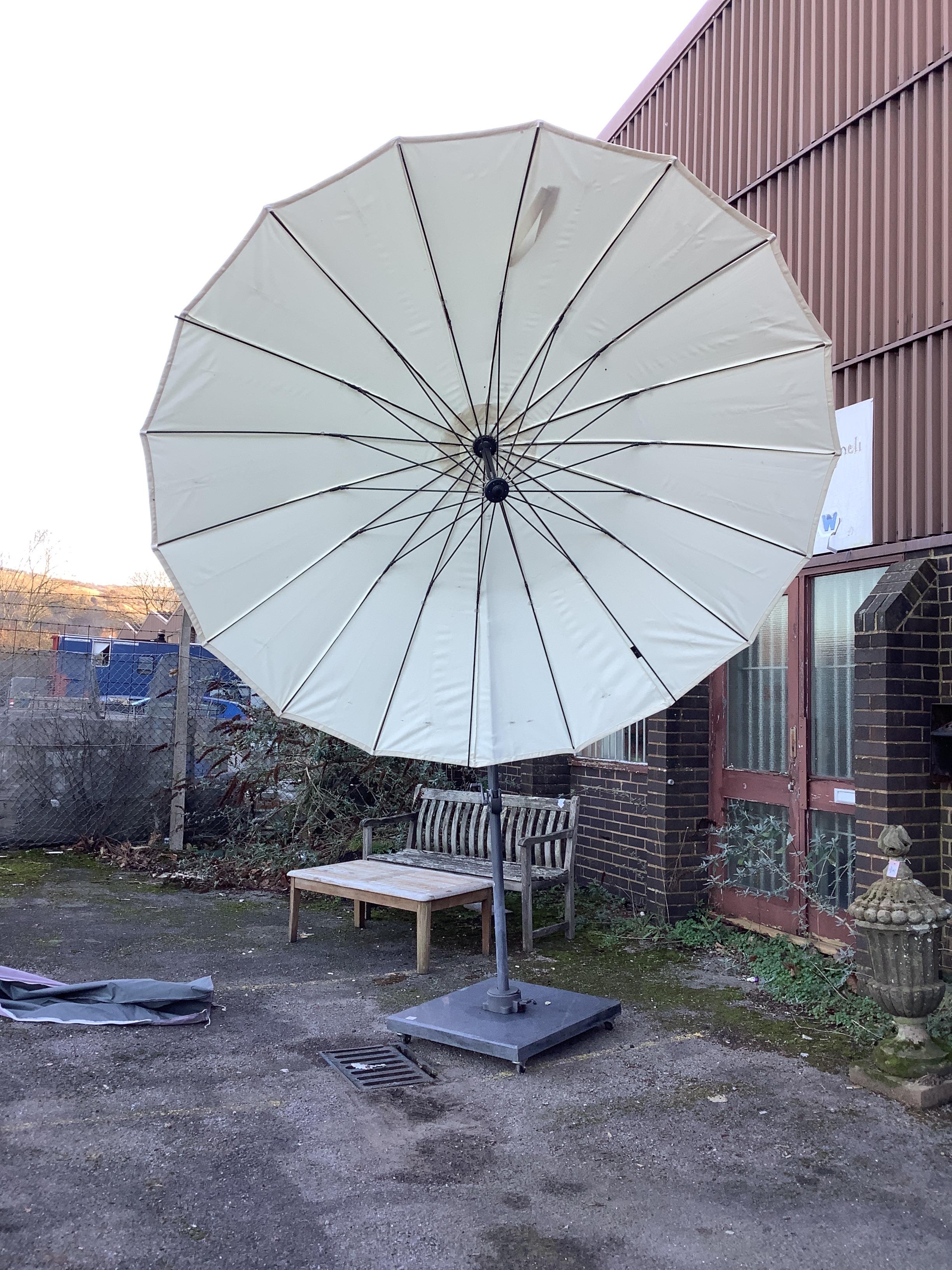 A large garden crank parasol and base
